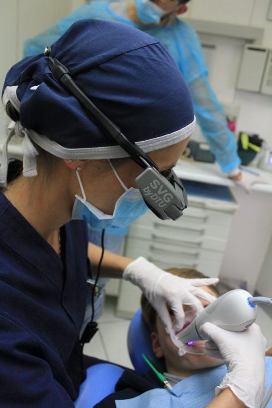 dentists performing laser surgery