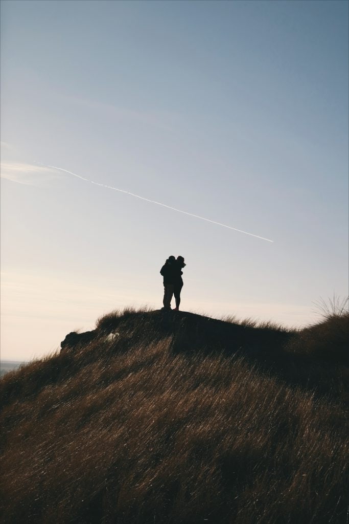 couples kissing on mountain top