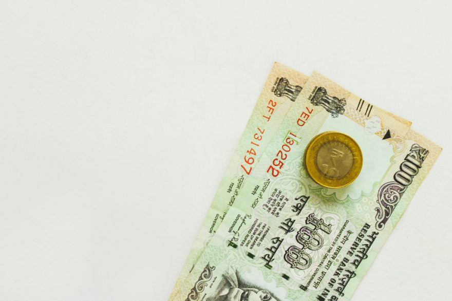 rupee note with coin